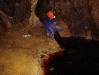 Jill Randall testing etching plates in sulphurous pool underground.